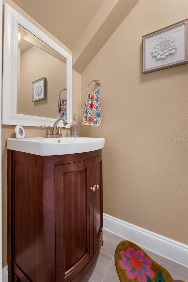 752 Howland Ln Unit 114, Altamonte Springs, FL 32701 - bathroom featuring vanity, vaulted ceiling, and baseboards