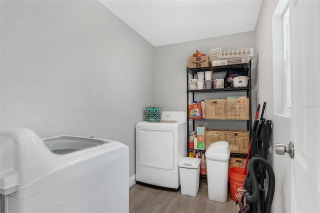 752 Howland Ln Unit 114, Altamonte Springs, FL 32701 - laundry room with washing machine and clothes dryer, light wood-type flooring, and baseboards