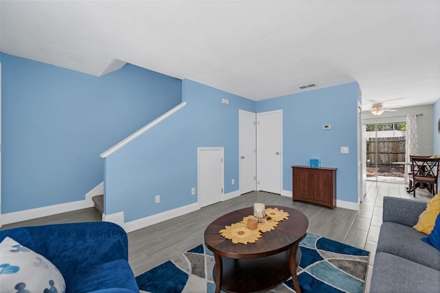 752 Howland Ln Unit 114, Altamonte Springs, FL 32701 - living room with stairway, wood finished floors, ceiling fan, and baseboards
