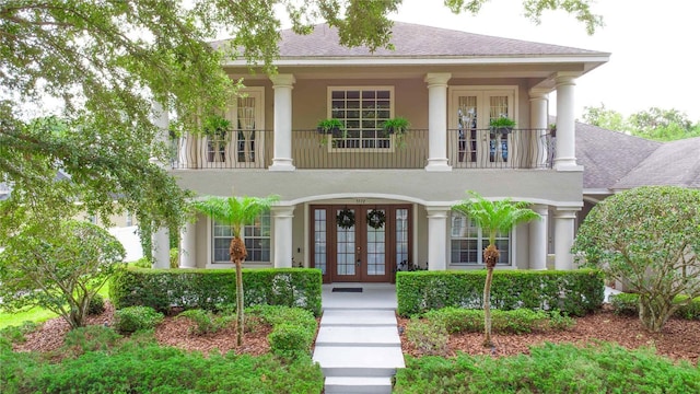 3372 Bellington Dr, Orlando, FL 32835 - neoclassical home with french doors, a balcony, and stucco siding