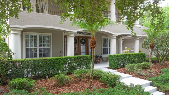 3372 Bellington Dr, Orlando, FL 32835 - entrance to property featuring stucco siding and a porch