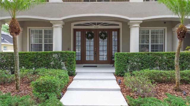 3372 Bellington Dr, Orlando, FL 32835 - property entrance featuring french doors, stucco siding, and covered porch
