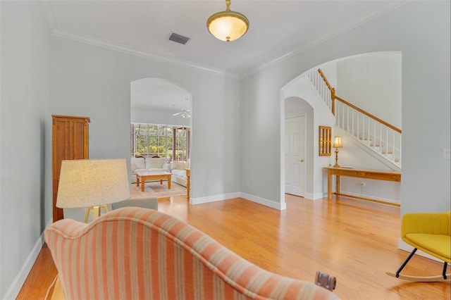 3372 Bellington Dr, Orlando, FL 32835 - living room with arched walkways, wood finished floors, stairway, crown molding, and baseboards