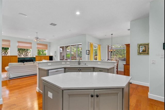 3372 Bellington Dr, Orlando, FL 32835 - kitchen with a center island with sink, a sink, a chandelier, plenty of natural light, and recessed lighting