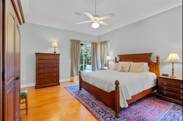 3372 Bellington Dr, Orlando, FL 32835 - bedroom featuring access to exterior, light wood-style floors, baseboards, and ceiling fan