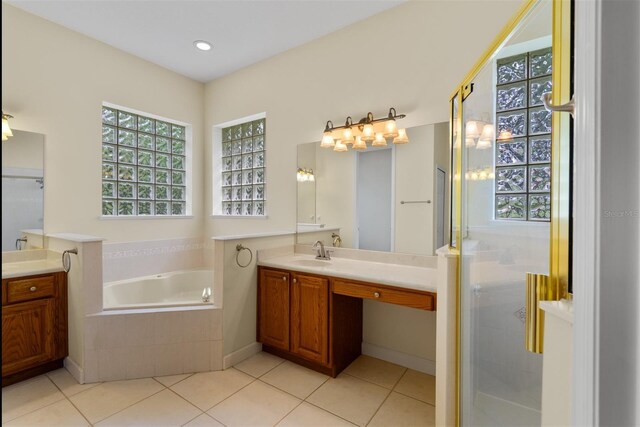 3372 Bellington Dr, Orlando, FL 32835 - bathroom with vanity, a garden tub, tile patterned flooring, and a stall shower