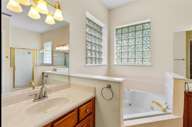 3372 Bellington Dr, Orlando, FL 32835 - full bath featuring a stall shower, a whirlpool tub, vanity, and a chandelier