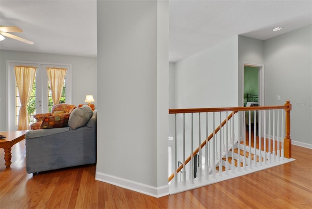 3372 Bellington Dr, Orlando, FL 32835 - hallway featuring an upstairs landing, wood finished floors, and baseboards