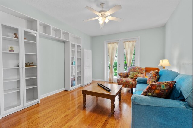 3372 Bellington Dr, Orlando, FL 32835 - living area with french doors, ceiling fan, light wood-style floors, and baseboards
