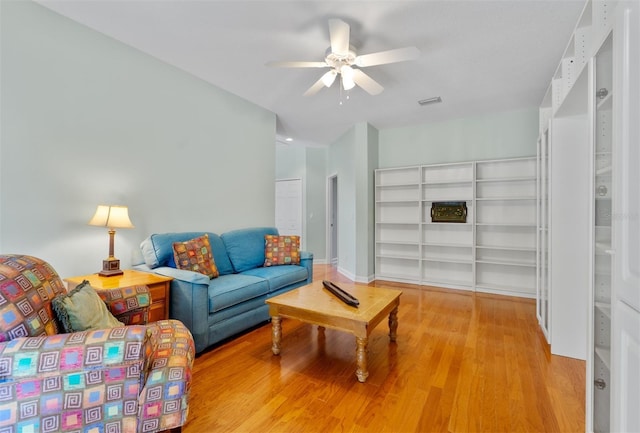 3372 Bellington Dr, Orlando, FL 32835 - living area with ceiling fan and light wood-style flooring