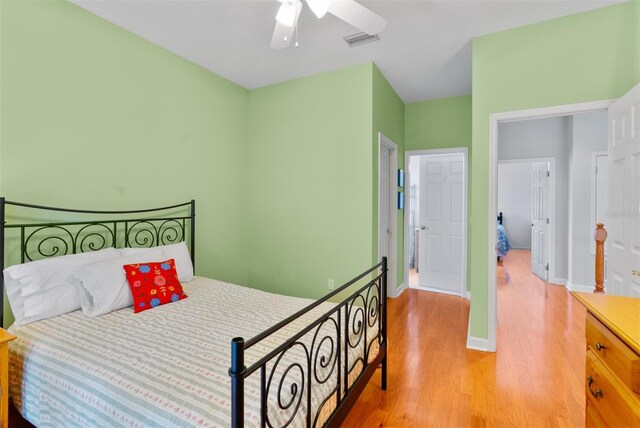 3372 Bellington Dr, Orlando, FL 32835 - bedroom with light wood-style flooring, a ceiling fan, and baseboards