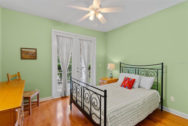 3372 Bellington Dr, Orlando, FL 32835 - bedroom featuring access to exterior, baseboards, wood finished floors, and a ceiling fan