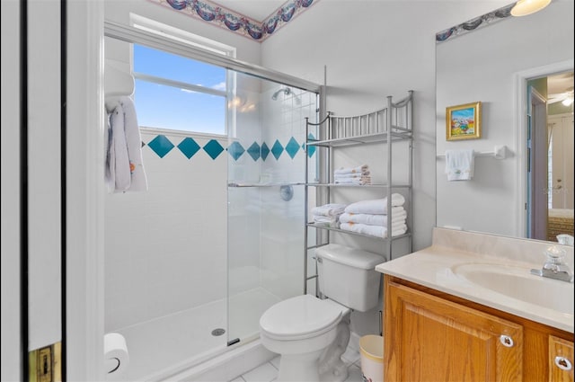 3372 Bellington Dr, Orlando, FL 32835 - bathroom featuring vanity, toilet, a shower stall, and tile patterned floors