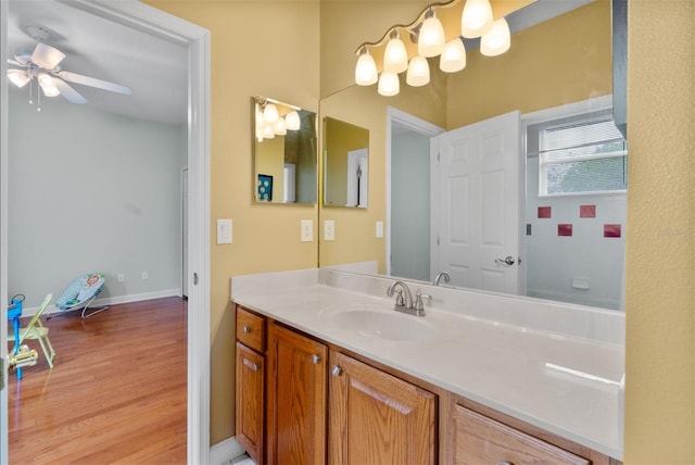3372 Bellington Dr, Orlando, FL 32835 - bathroom featuring vanity, ceiling fan, wood finished floors, and baseboards