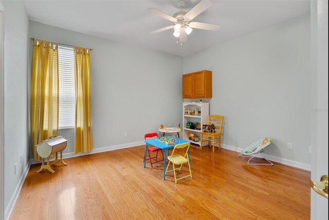 3372 Bellington Dr, Orlando, FL 32835 - rec room with light wood-style flooring, a ceiling fan, and baseboards