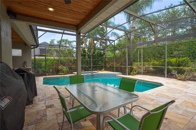 3372 Bellington Dr, Orlando, FL 32835 - view of swimming pool with a patio area, glass enclosure, and a pool with connected hot tub