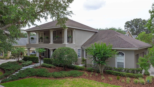 3372 Bellington Dr, Orlando, FL 32835 - neoclassical home with a balcony, stucco siding, and a shingled roof