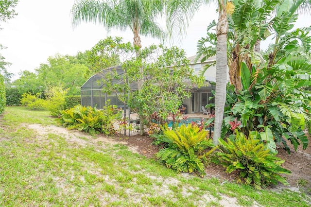 3372 Bellington Dr, Orlando, FL 32835 - view of grassy yard featuring a lanai