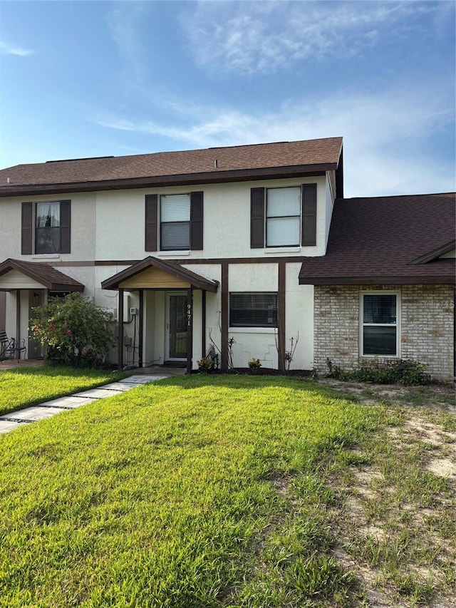 9471 Comeau St, Gotha, FL 34734 - view of front facade with stucco siding, a front yard, and roof with shingles