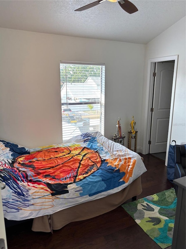 9471 Comeau St, Gotha, FL 34734 - bedroom featuring dark wood-type flooring, a textured ceiling, and a ceiling fan