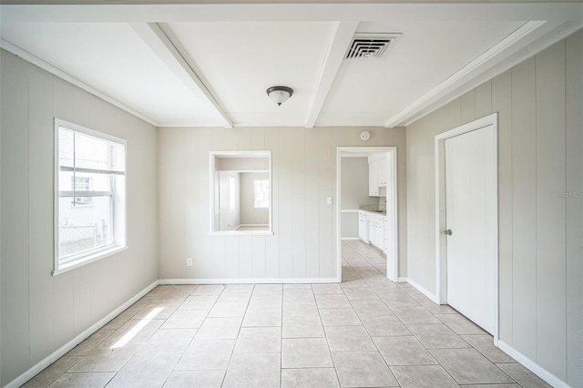 2307 Freemason St, Lakeland, FL 33801 - empty room with beam ceiling, light tile patterned floors, and ornamental molding