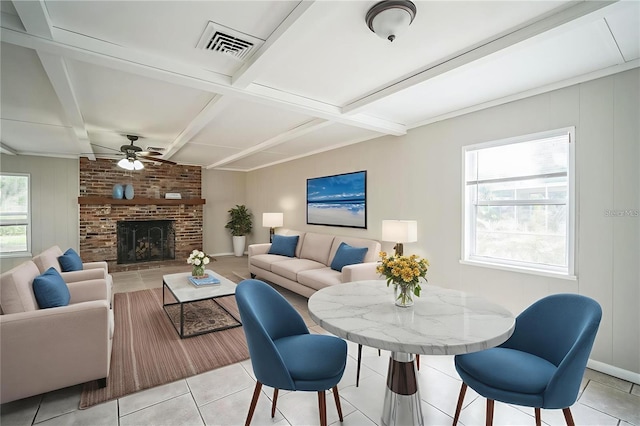 2307 Freemason St, Lakeland, FL 33801 - living room with ceiling fan, beam ceiling, light tile patterned flooring, and a brick fireplace