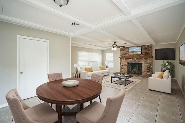 2307 Freemason St, Lakeland, FL 33801 - dining area with light tile patterned floors, a ceiling fan, beamed ceiling, a brick fireplace, and coffered ceiling