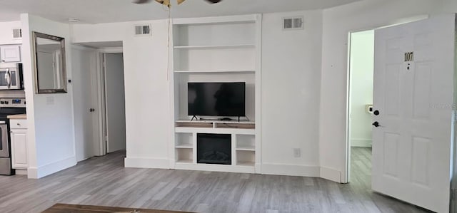320 Forestway Cir Unit 107, Altamonte Springs, FL 32701 - unfurnished living room featuring wood finished floors, ceiling fan, and built in features