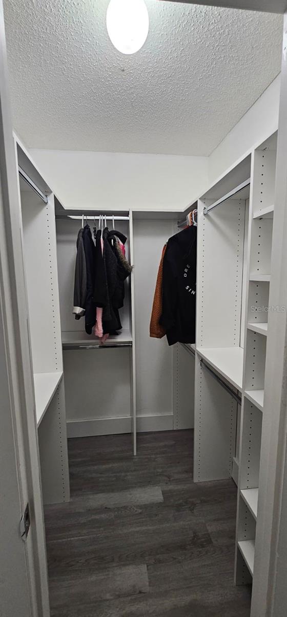 320 Forestway Cir Unit 107, Altamonte Springs, FL 32701 - walk in closet featuring wood finished floors