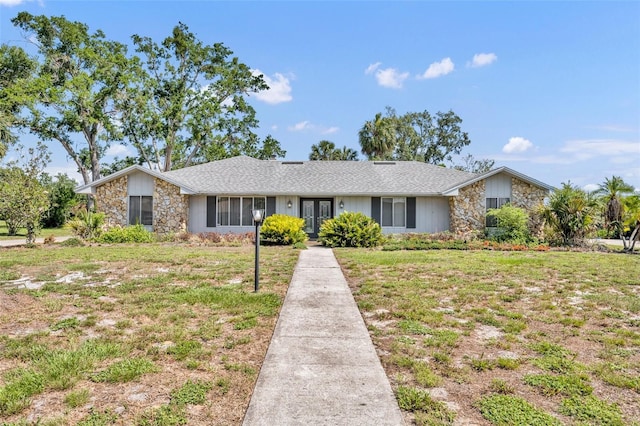 1115 Lake Francis Dr, Apopka, FL 32712 - view of front of property featuring french doors, stone siding, and a front lawn