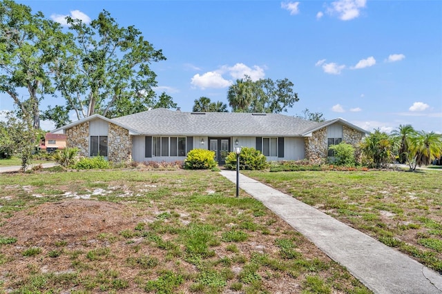 1115 Lake Francis Dr, Apopka, FL 32712 - view of front facade with stone siding, a front lawn, and french doors