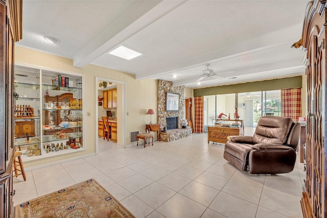 1115 Lake Francis Dr, Apopka, FL 32712 - living area with beamed ceiling, a fireplace, light tile patterned flooring, a textured ceiling, and a ceiling fan