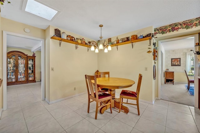 1115 Lake Francis Dr, Apopka, FL 32712 - dining space featuring a chandelier, light tile patterned floors, baseboards, and a skylight