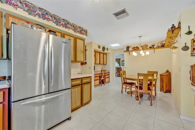 1115 Lake Francis Dr, Apopka, FL 32712 - kitchen featuring freestanding refrigerator, a chandelier, light countertops, light tile patterned floors, and decorative light fixtures
