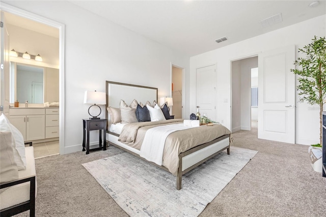 52 W Harding St Unit A, Orlando, FL 32806 - bedroom with light carpet, connected bathroom, and baseboards