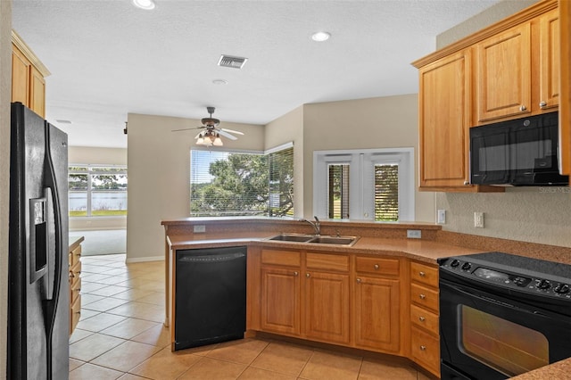 16729 Tall Grass Ln, Clermont, FL 34711 - kitchen featuring black appliances, a sink, a peninsula, light tile patterned floors, and ceiling fan