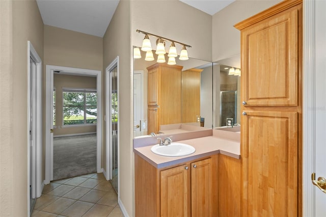 16729 Tall Grass Ln, Clermont, FL 34711 - bathroom with tile patterned flooring, vanity, a shower with door, and baseboards