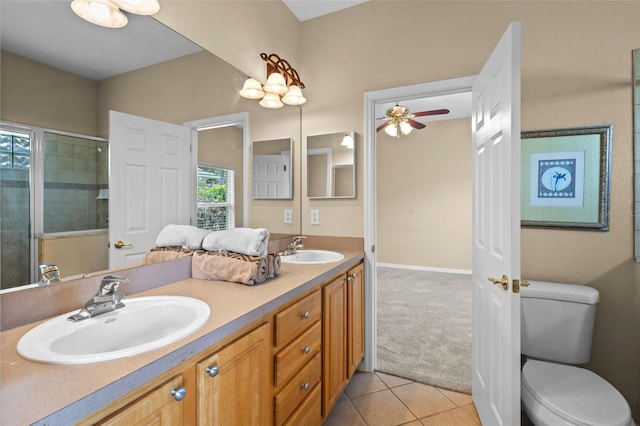 16729 Tall Grass Ln, Clermont, FL 34711 - bathroom with double vanity, tile patterned flooring, a ceiling fan, toilet, and tiled shower