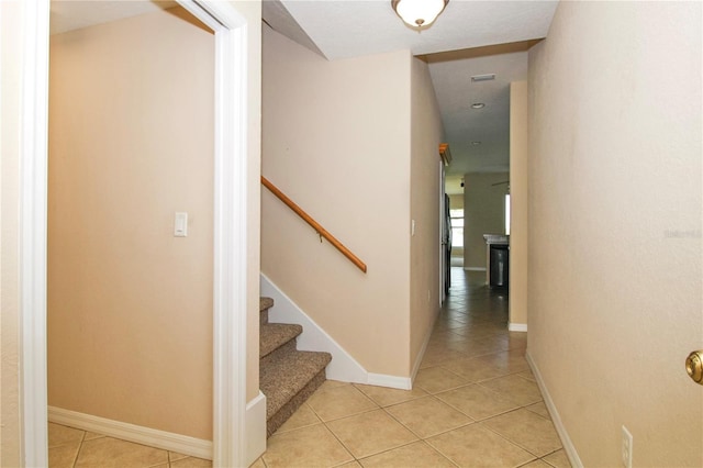 16729 Tall Grass Ln, Clermont, FL 34711 - corridor featuring light tile patterned flooring and stairs