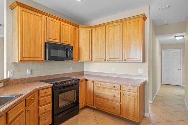 16729 Tall Grass Ln, Clermont, FL 34711 - kitchen featuring black appliances, light tile patterned floors, and light countertops