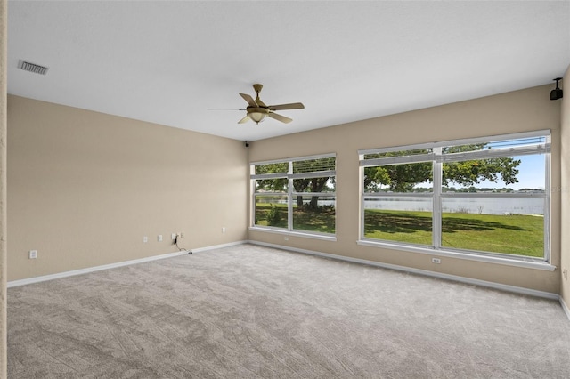 16729 Tall Grass Ln, Clermont, FL 34711 - empty room with plenty of natural light, a ceiling fan, and carpet