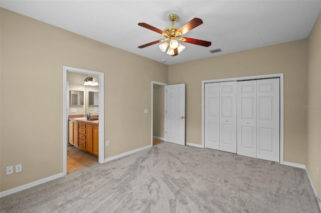16729 Tall Grass Ln, Clermont, FL 34711 - unfurnished bedroom featuring light colored carpet, a closet, a ceiling fan, and ensuite bathroom