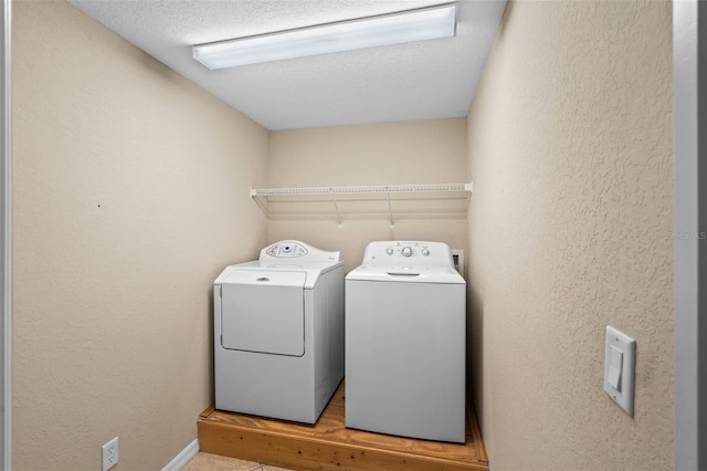 16729 Tall Grass Ln, Clermont, FL 34711 - washroom with washer and clothes dryer, a textured ceiling, and a textured wall