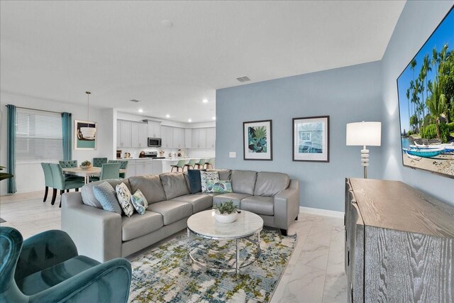 9239 Sommerset Hills Dr, Davenport, FL 33896 - living area with light marble finish floors, recessed lighting, and baseboards