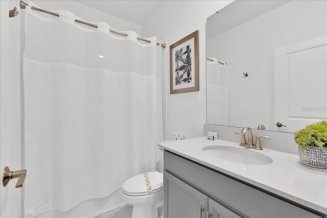 9239 Sommerset Hills Dr, Davenport, FL 33896 - full bathroom with vanity, shower / bath combo with shower curtain, and toilet