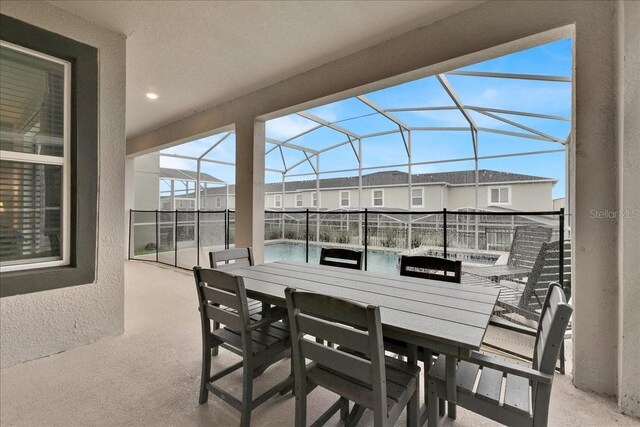 9239 Sommerset Hills Dr, Davenport, FL 33896 - view of patio with an outdoor pool, glass enclosure, a residential view, and outdoor dining space