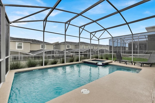 9239 Sommerset Hills Dr, Davenport, FL 33896 - view of swimming pool featuring a patio, a pool with connected hot tub, and glass enclosure