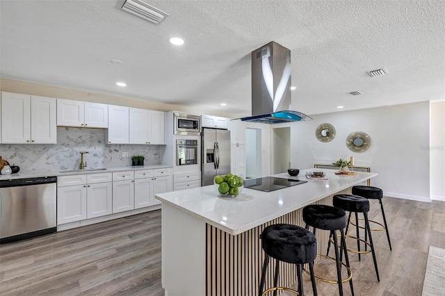 822 Glen Arden Way, Altamonte Springs, FL 32701 - kitchen featuring stainless steel appliances, island range hood, a sink, a breakfast bar area, and white cabinets