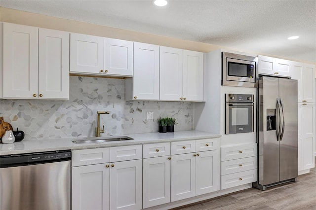 822 Glen Arden Way, Altamonte Springs, FL 32701 - kitchen featuring appliances with stainless steel finishes, a sink, white cabinetry, light countertops, and recessed lighting