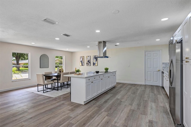 822 Glen Arden Way, Altamonte Springs, FL 32701 - kitchen featuring island exhaust hood, freestanding refrigerator, light wood-type flooring, recessed lighting, and a textured ceiling